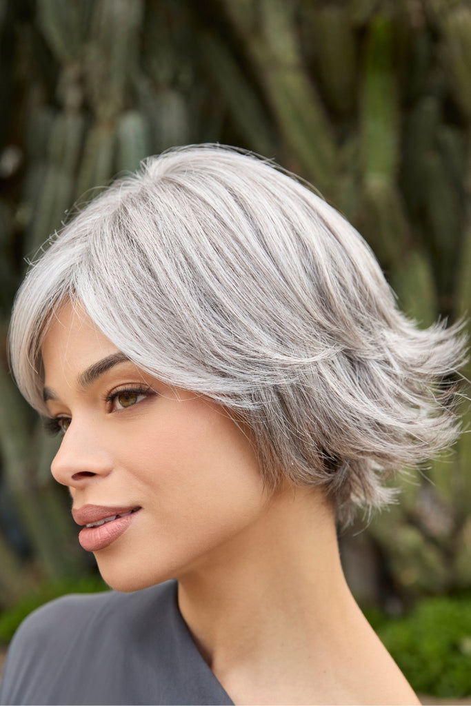 Model wearing the color Silver Stone in a soft wispy wig.
