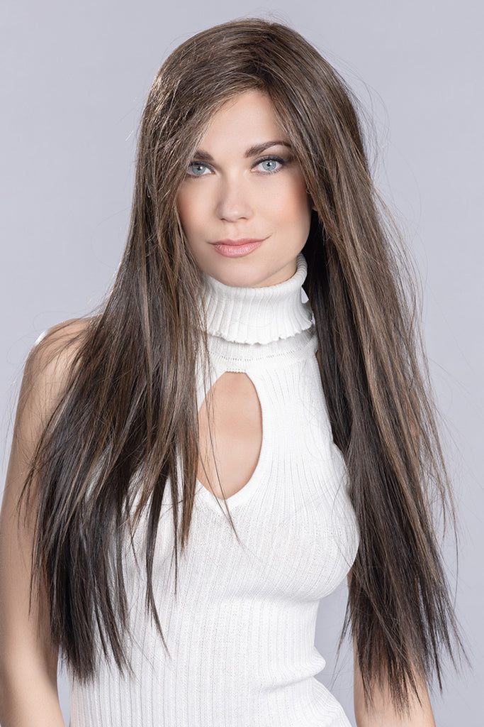 Front photo of a woman wearing the long synthetic wig. 