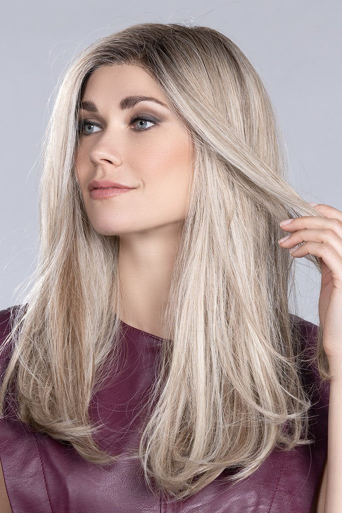 Side view of women wearing trendy and chic wig with heat friendly synthetic hair fibers.