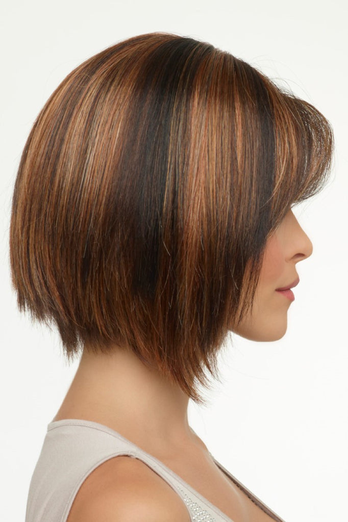 Model looking to the side wearing a layered A-line bob wig.