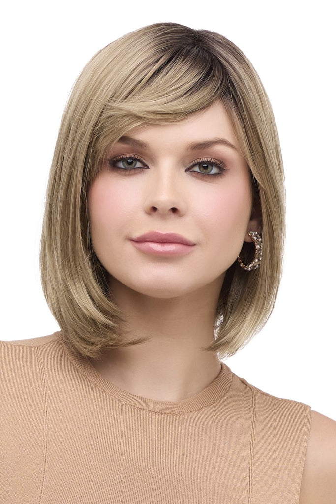 Women styling Envy Wigs Petite Paige in the color Golden Sandstone.