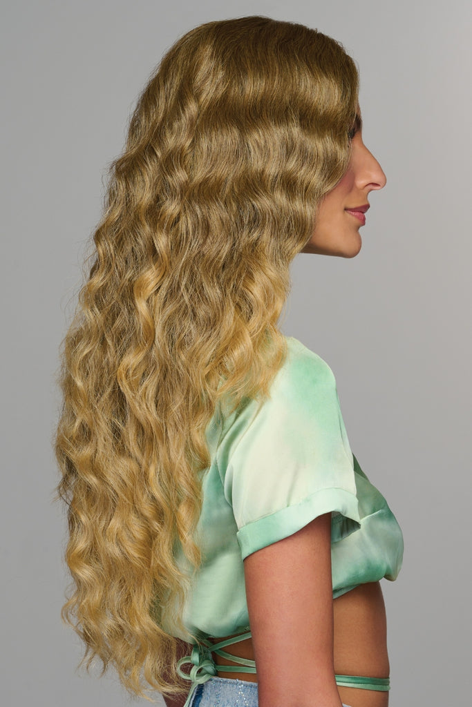 Side view of woman wearing Curly Girlie by Hairdo. 