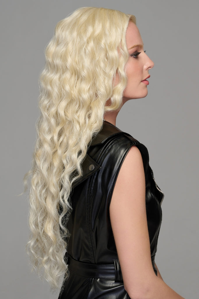 Side view of the model wearing the long curly wig.