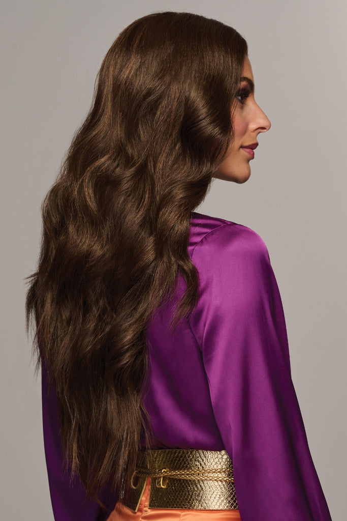 Side view of a woman wearing the long wavy style.