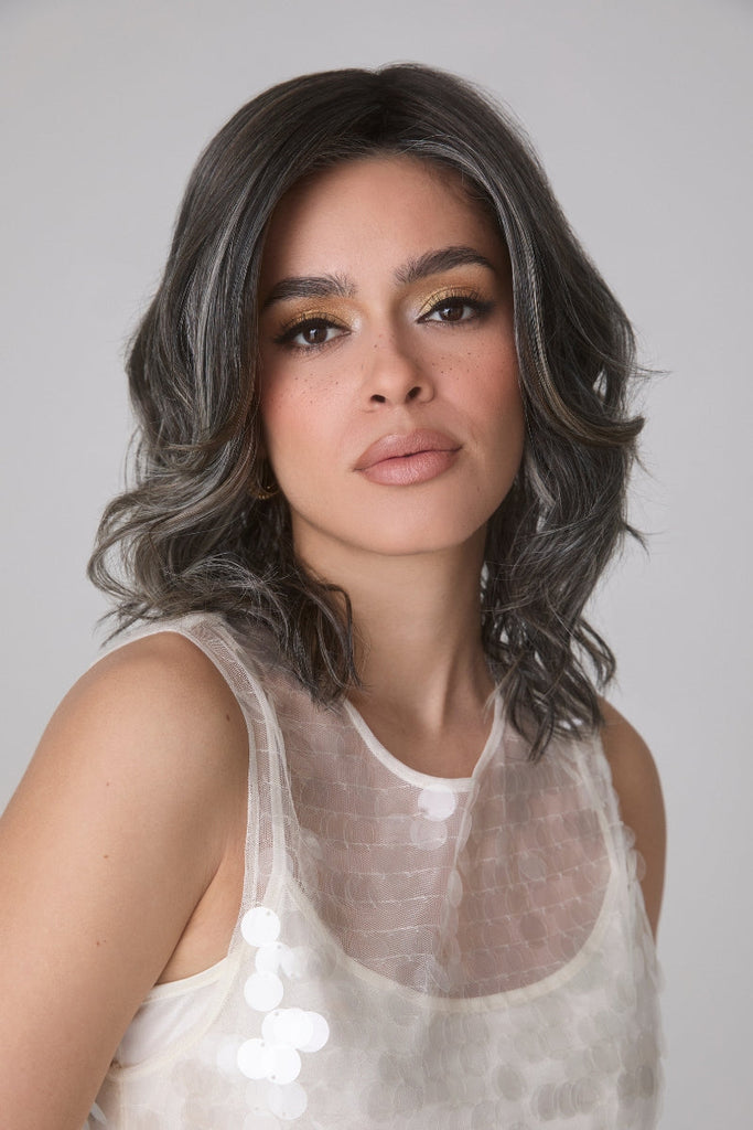 Woman modeling a curly wig in the color Truffle Ribbon-R.