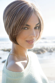 Women wearing a chic a-line cut bob by Amore in a brunette shade.