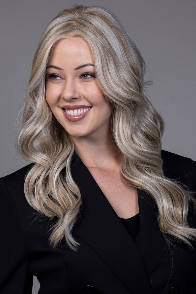 Woman wearing the long curly style by Belle Tress.