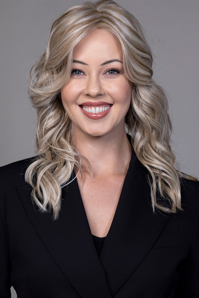 Woman styling Elle by Belle Tress wigs.