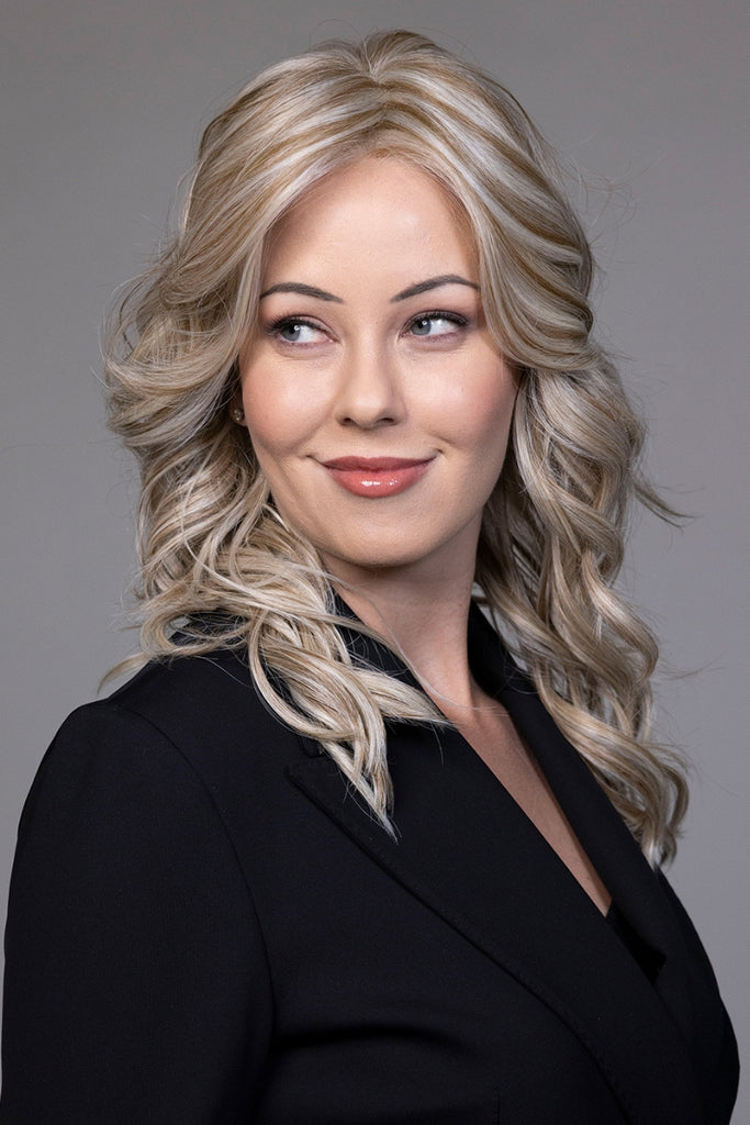 Model wearing a long curly wig.