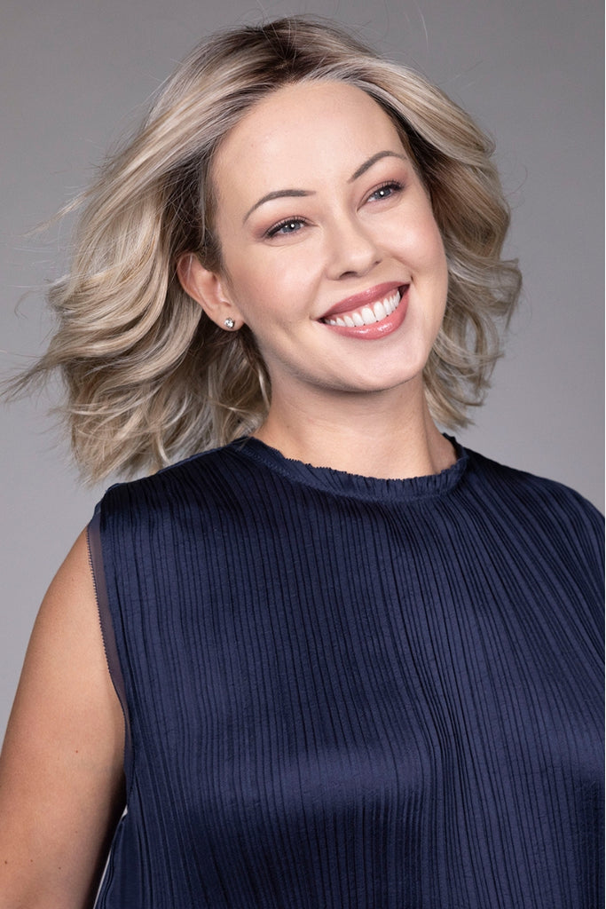 Model styling a dimensional blonde color.