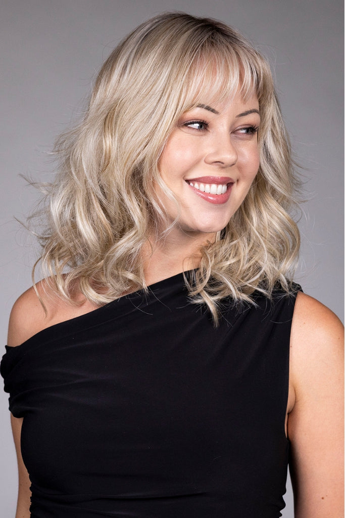 Model styling a dimensional blonde color.