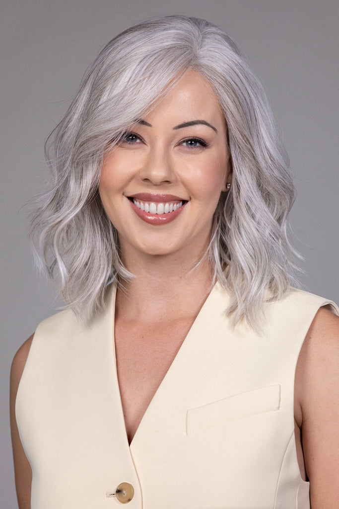 Woman wearing a medium length wavy wig. 