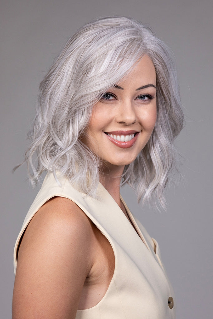 Side view of model styling a shoulder length wig by Belle Tress called Singapore.