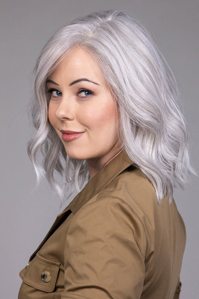 Side view of model wearing a wig in the color Oyster Gray.
