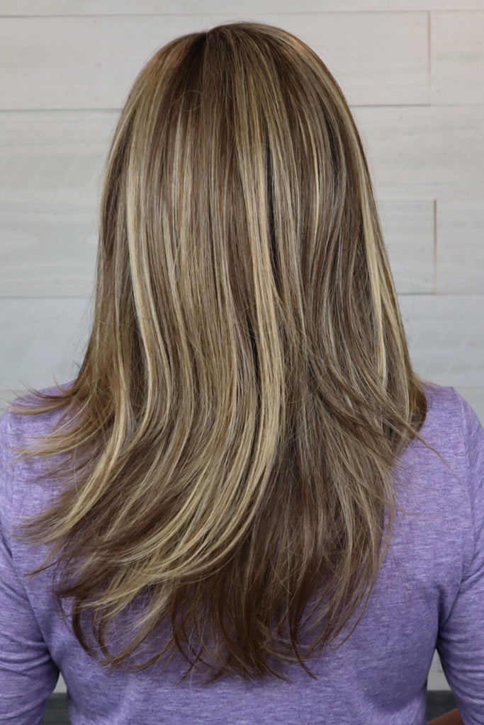 Back of women wearing a long, straight, layered wig.