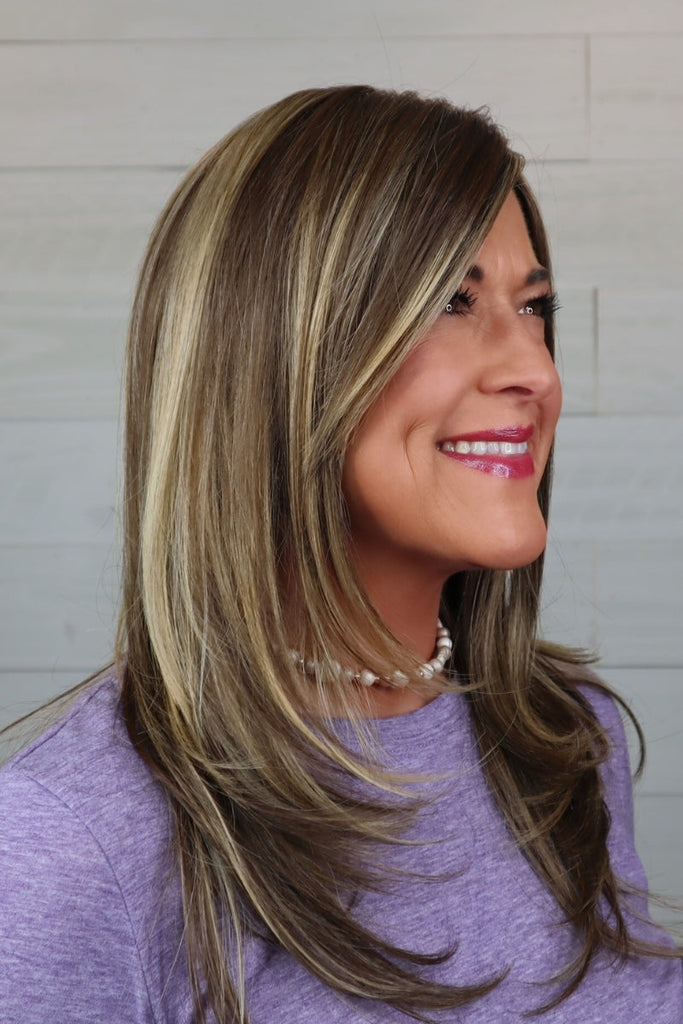 Side profile of women wearing a 100% hand tied wig.