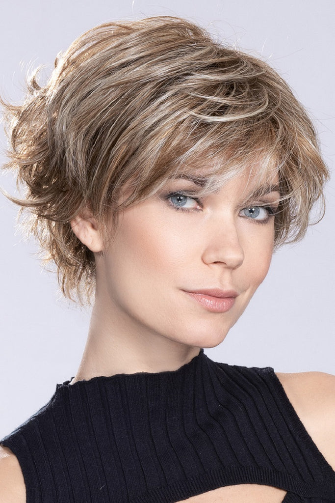 Photo of a woman wearing the short layered wig. 