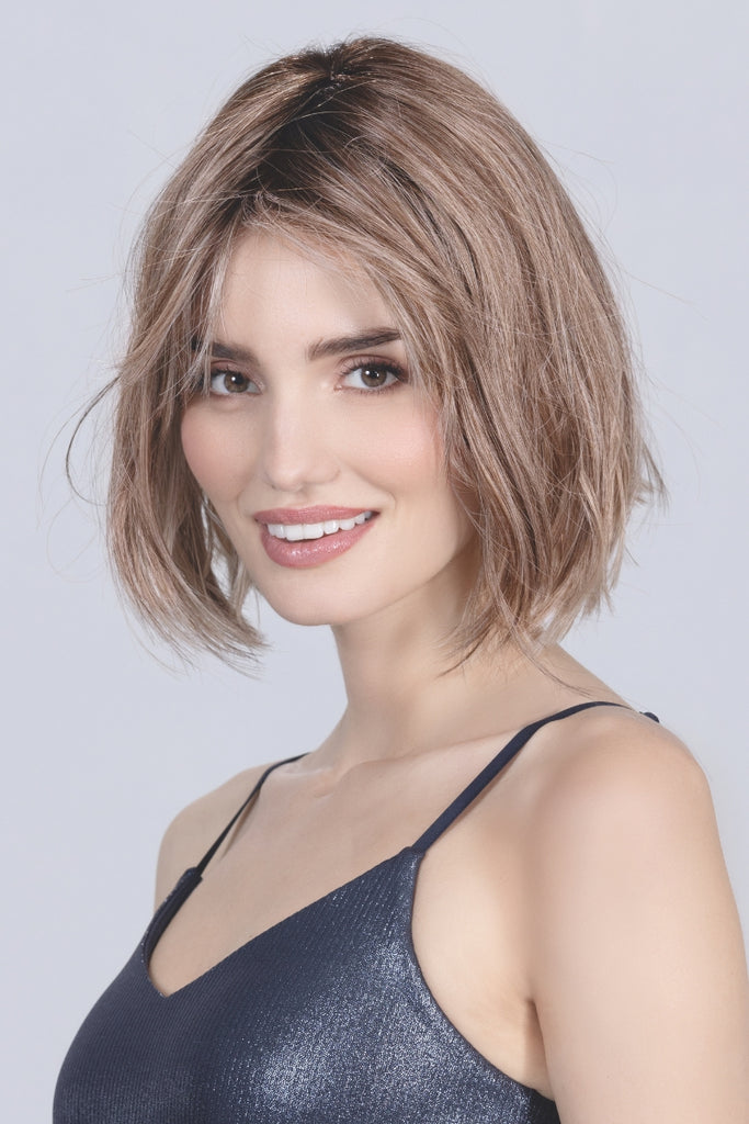 Woman wearing the medium length wig with versatile bangs.