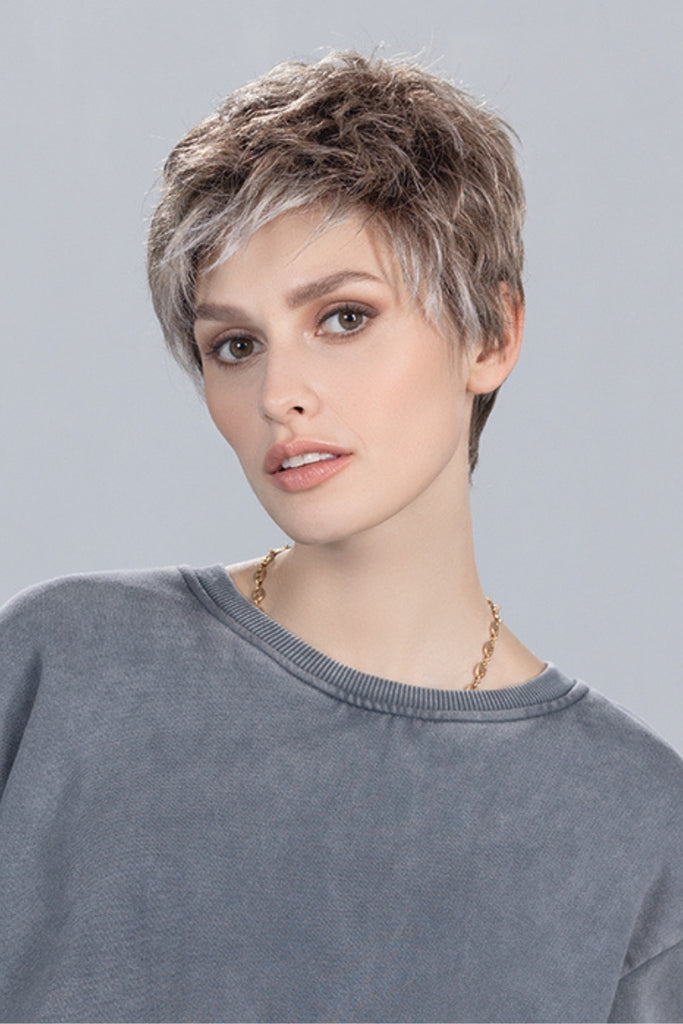 Model wearing a short, pixie cut wig.