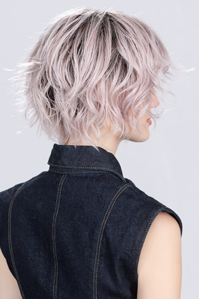 Side view of woman wearing a curly bob style.