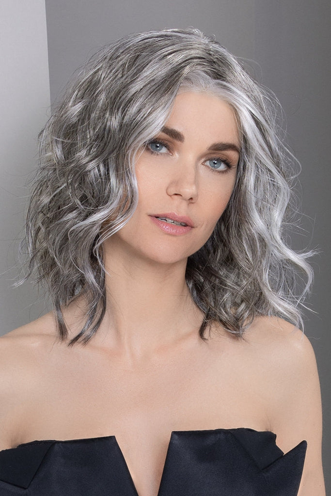 Woman wearing a medium length bob cut wig with natural movement.