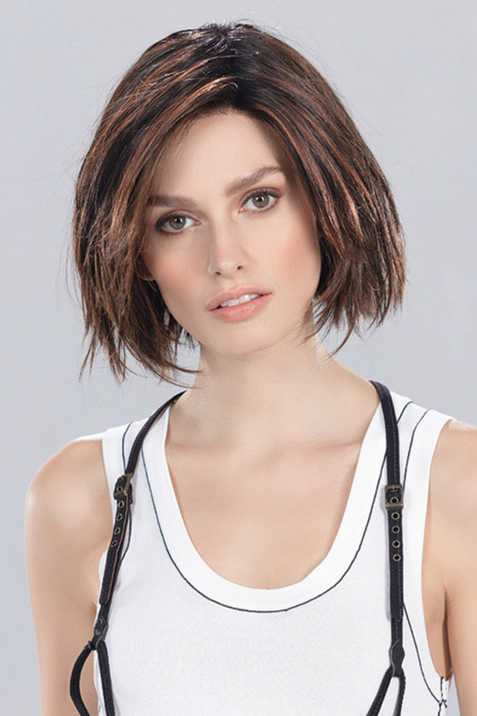 Model styling a Dark Auburn Rooted wig by Ellen Wille.
