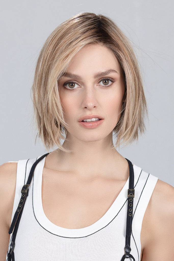 Model styling a medium length bob wig.