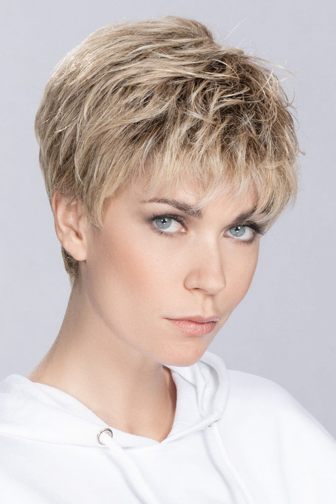 Side view of women wearing a luxurious high heat synthetic wig.