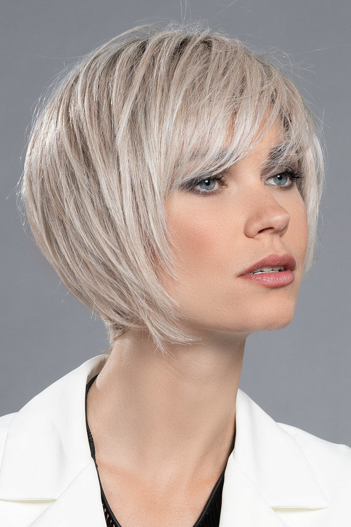 Model styling a pearl platinum, dark ash blonde, and medium honey blonde mix.
