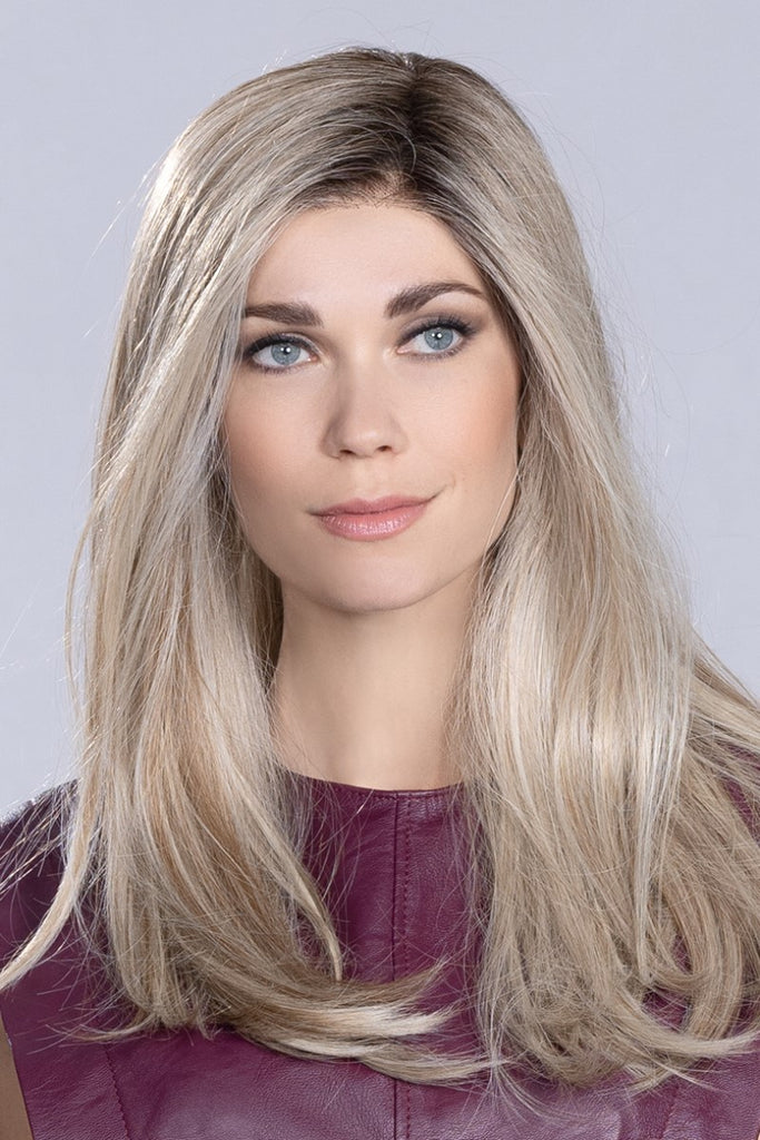 Women wearing a long length wig styled with subtle layering.