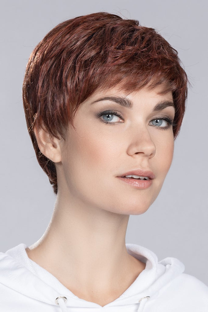 Women wearing a Ellen Wille Wig in the color Cherry Red Rooted, a blend of bright red and auburn red. 