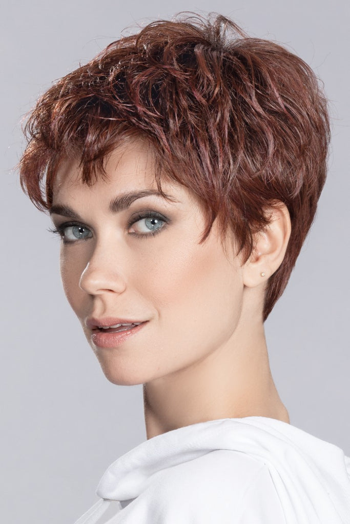 Side view of model wearing a short layered wig called Yoko.