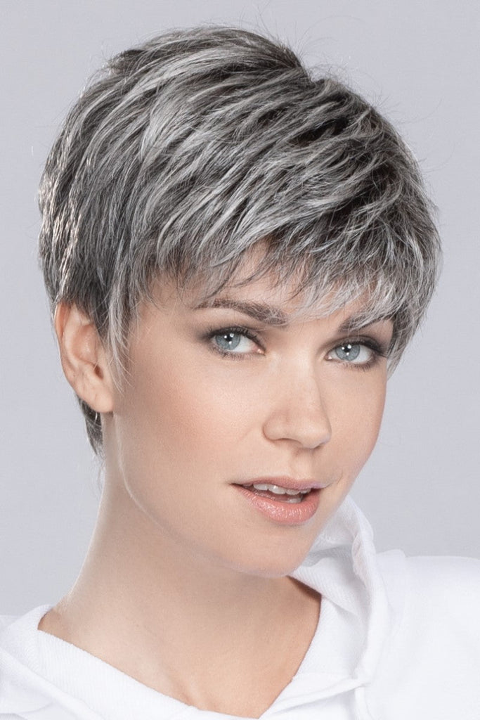 Side of women in Yoko a short and straight edgy modern wig.