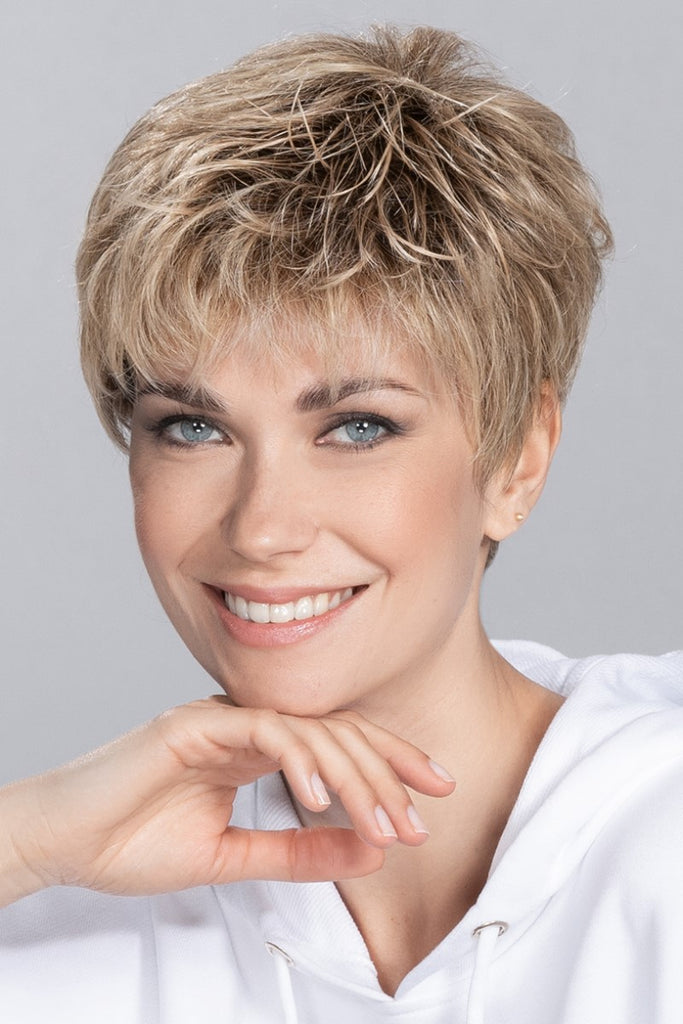 Front view of women smiling into the camera wearing a short pixie cut wig by Ellen Wille.