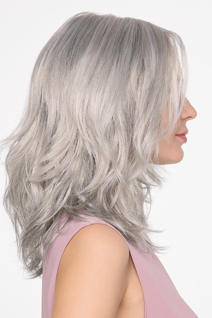Side view of woman wearing Amanda in a dimensional grey color.