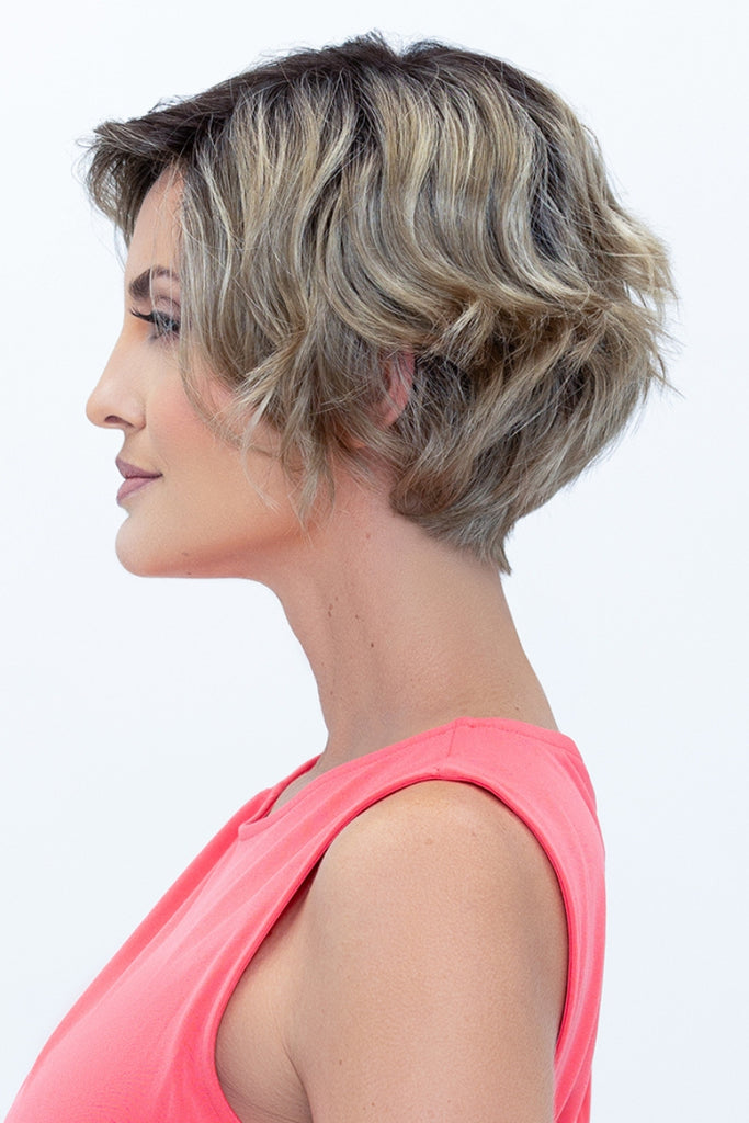 Woman styling a dark, dimensional blonde.