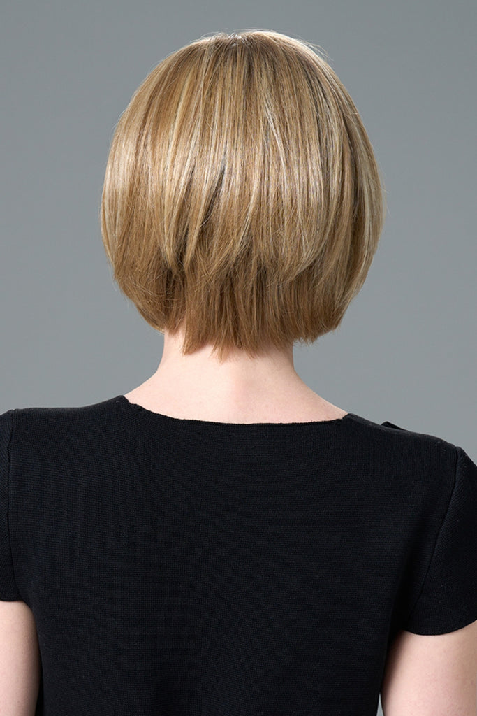 Back of model styling a bob wig.