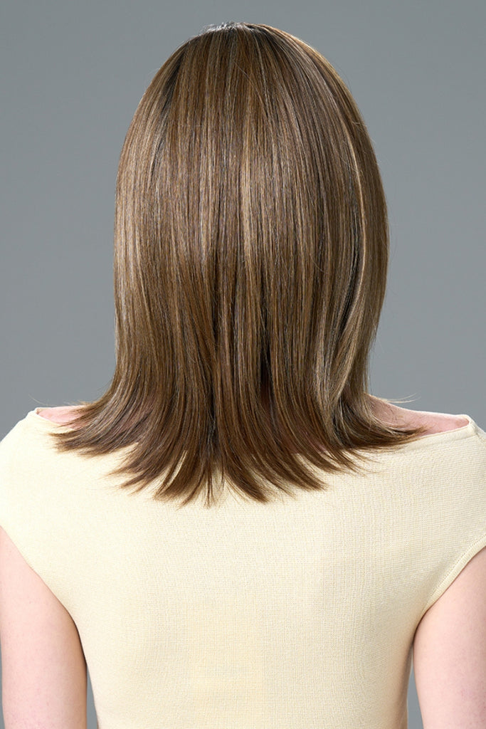 Back of model wearing a long layered wig.