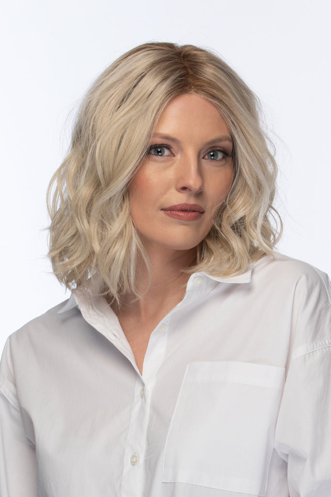 Model wearing a medium length wavy wig.