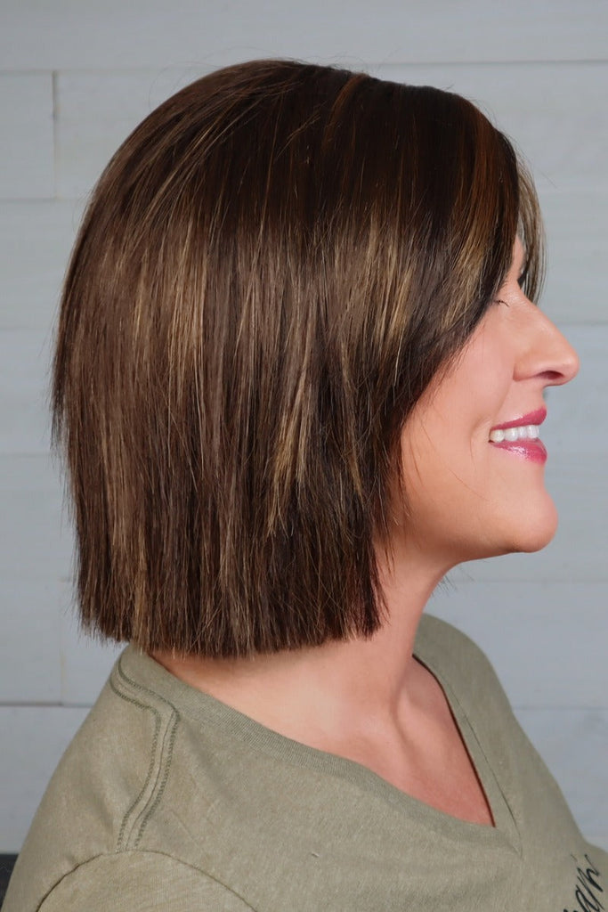 Side view of model styling a straight bob.