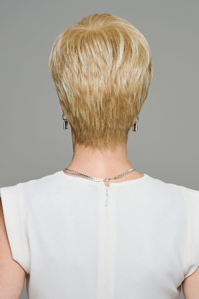 Back of model styling a layered pixie wig.