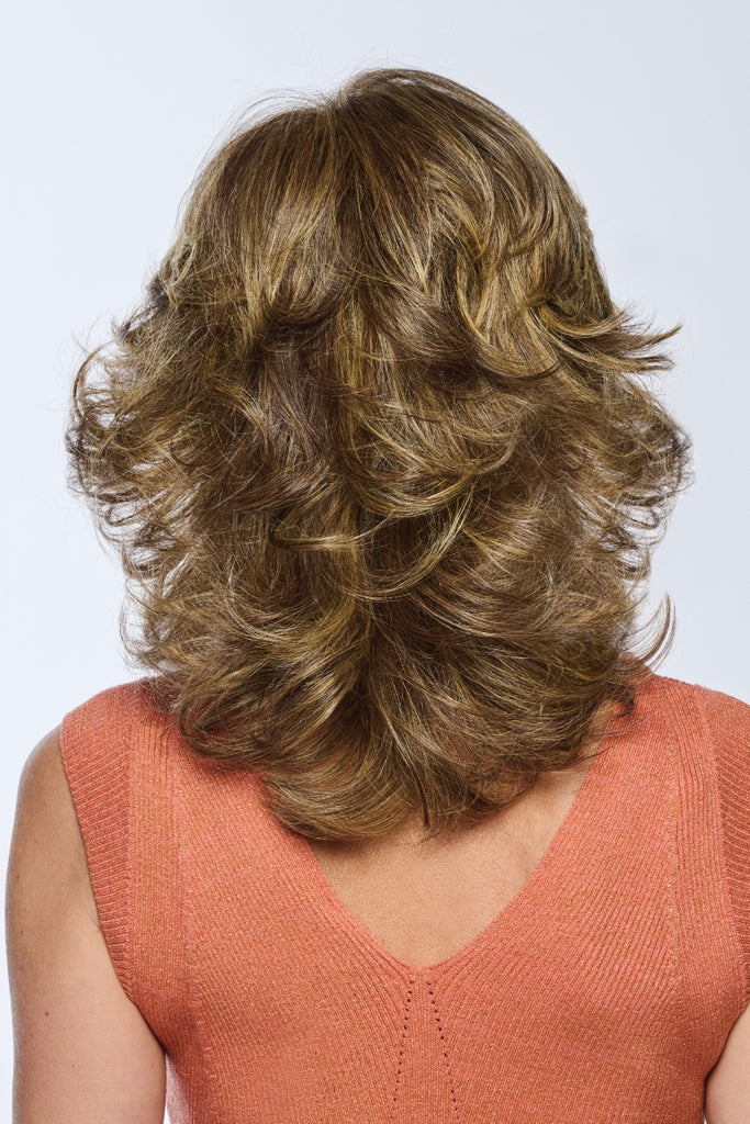 Back of model wearing a wig with barrel curls.