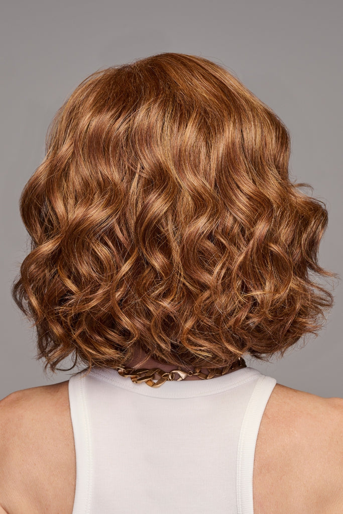 Back of model wearing a medium length wig.