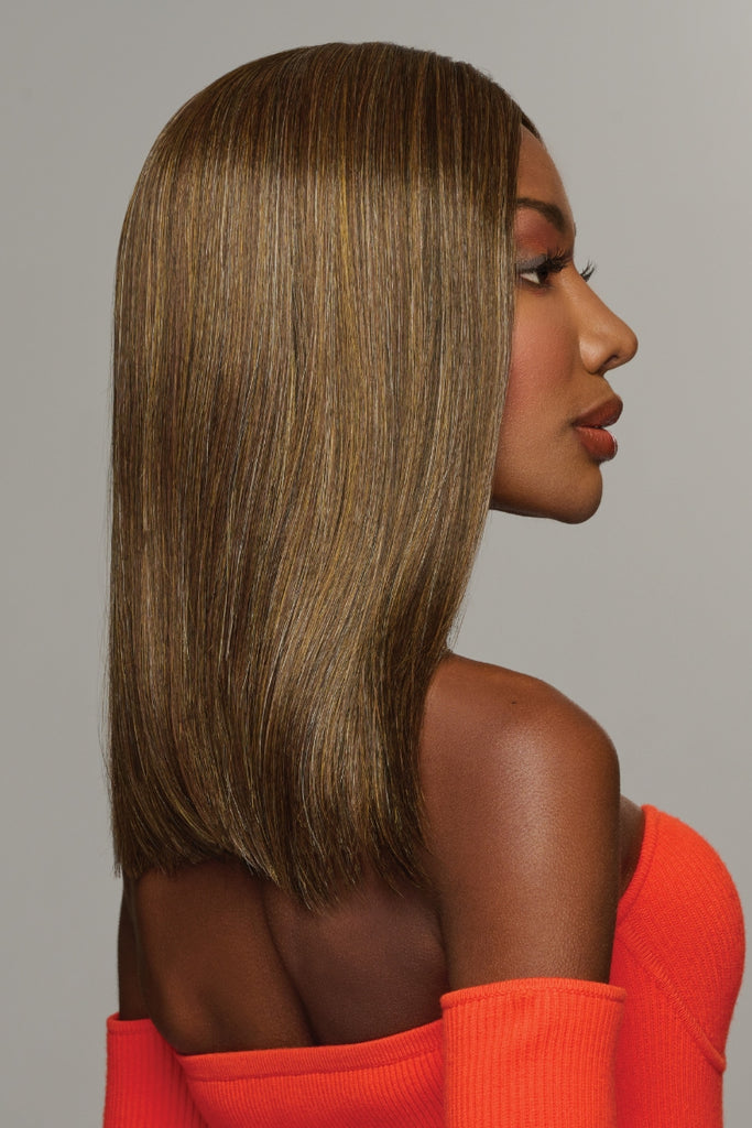 Side view of a model wearing the straight, medium length wig.