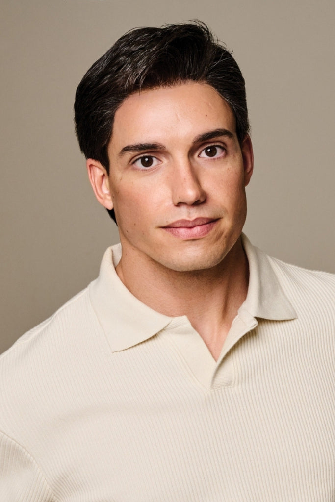 Close up of man styling a short length mens wig.