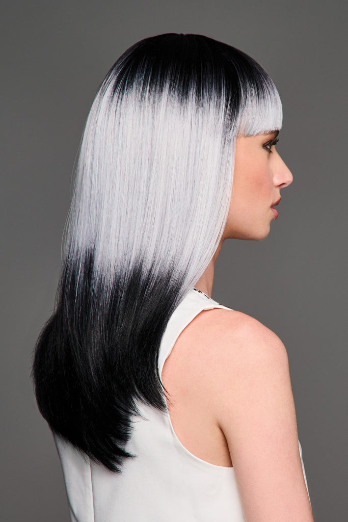 Side of woman wearing a multi colored wig.