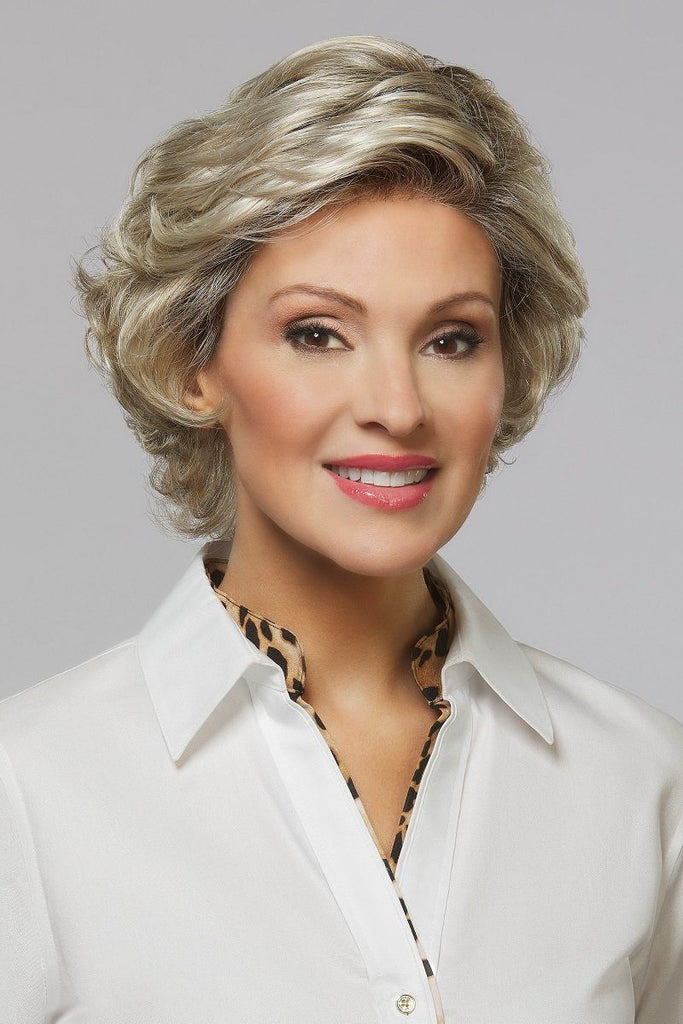Elegant mature woman wearing short slightly curled wig in a grey blonde.