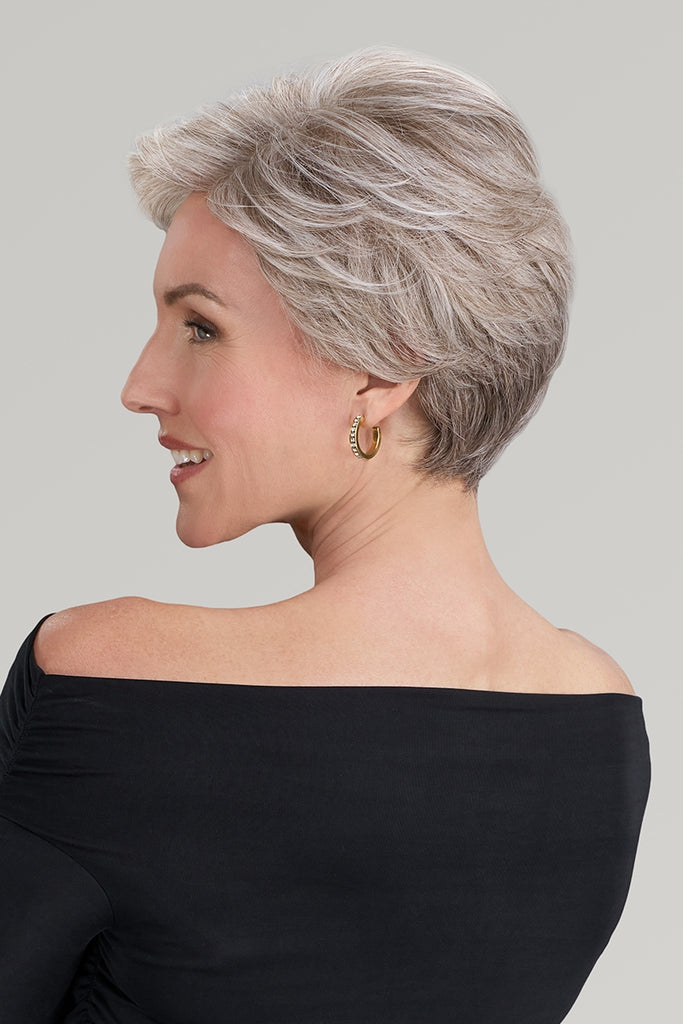 Side of model styling a pixie cut wig.