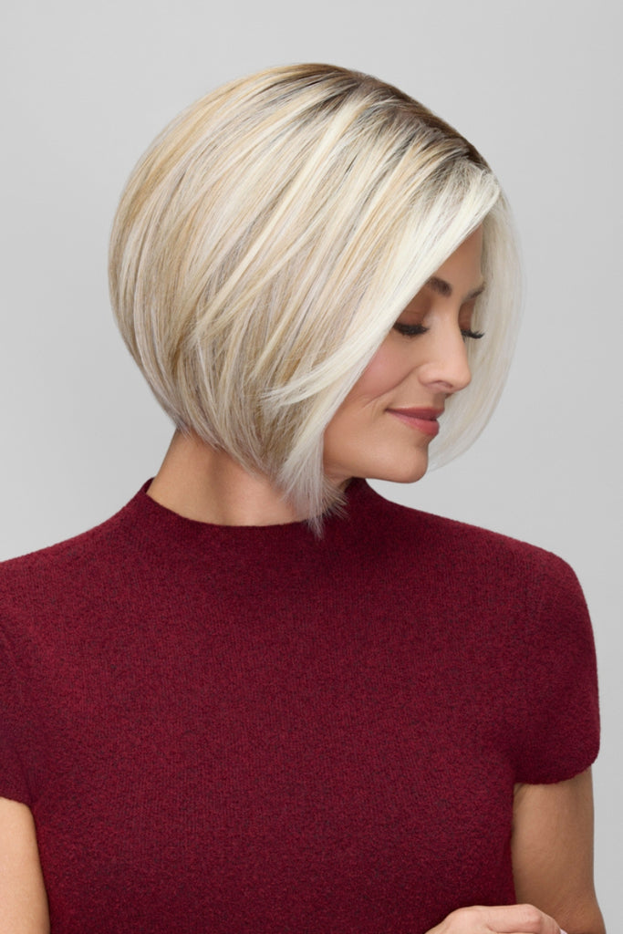 Side of model wearing a blonde bob wig.