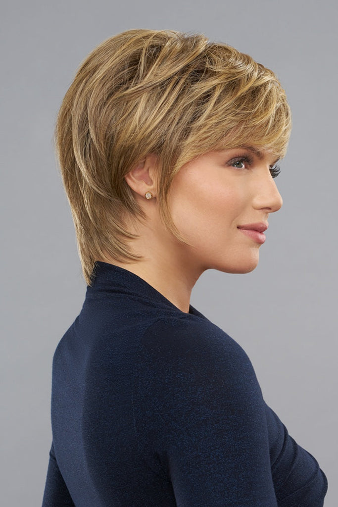 Model styling a layered shag cut wig.